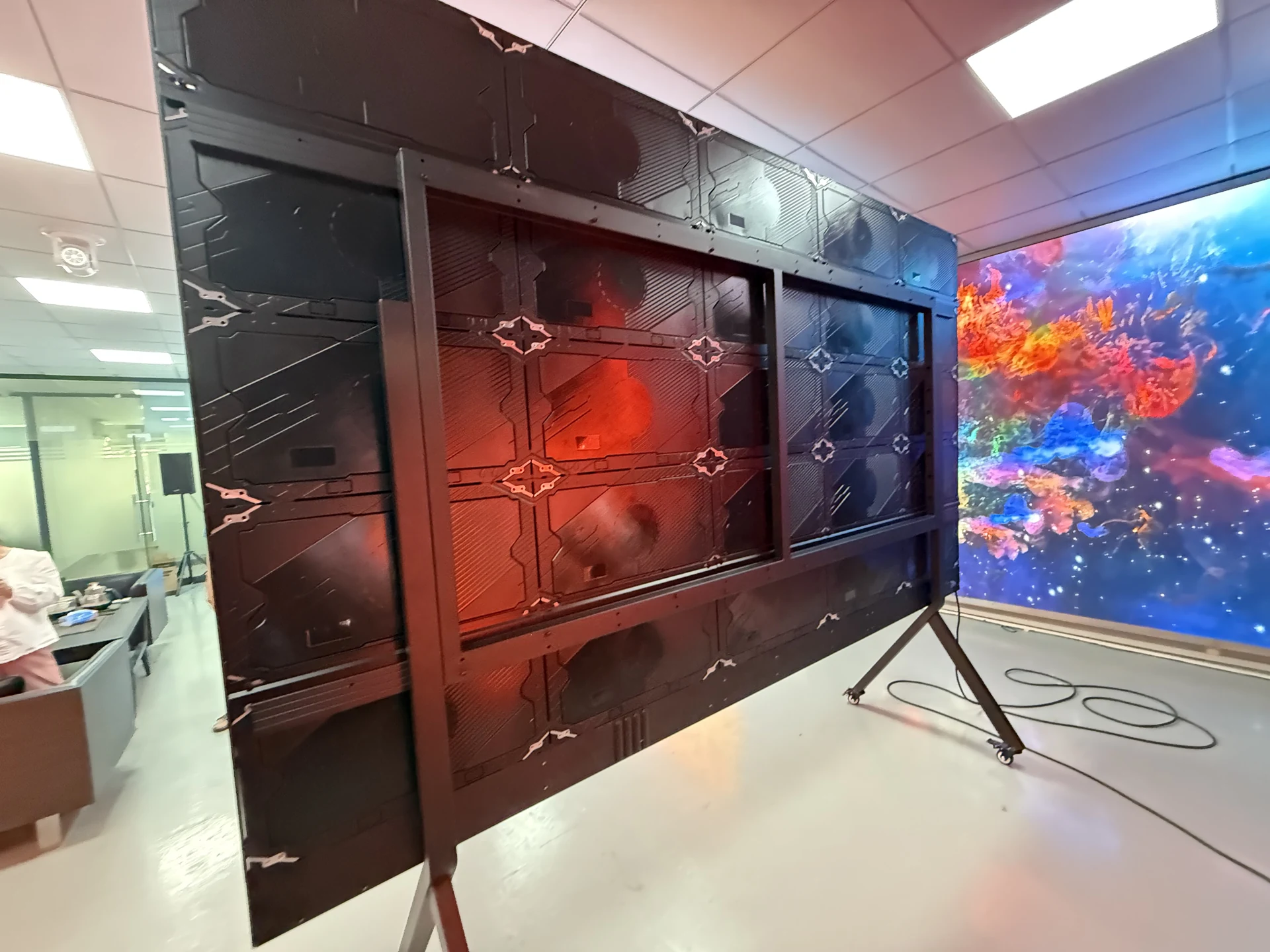 Rear structure and wheeled stand of an actual all-in-one LED display in a demonstration setting