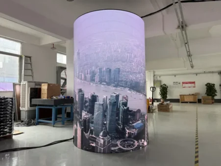 01 / Round column display showing cityscape content during factory playback