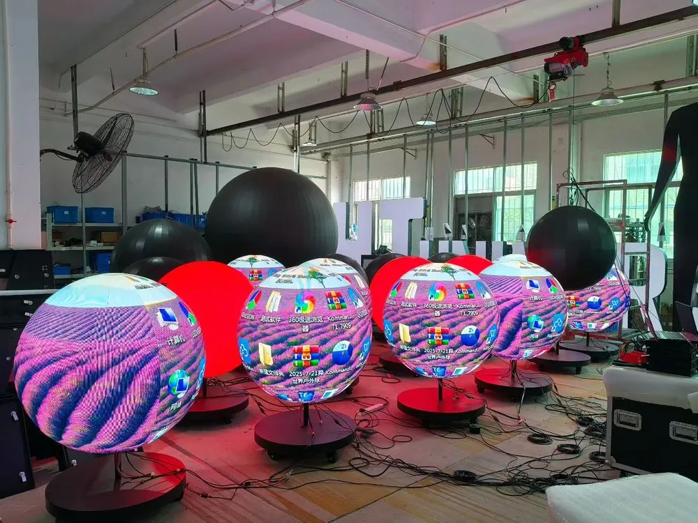 Several compact LED spheres on floor stands during a factory test